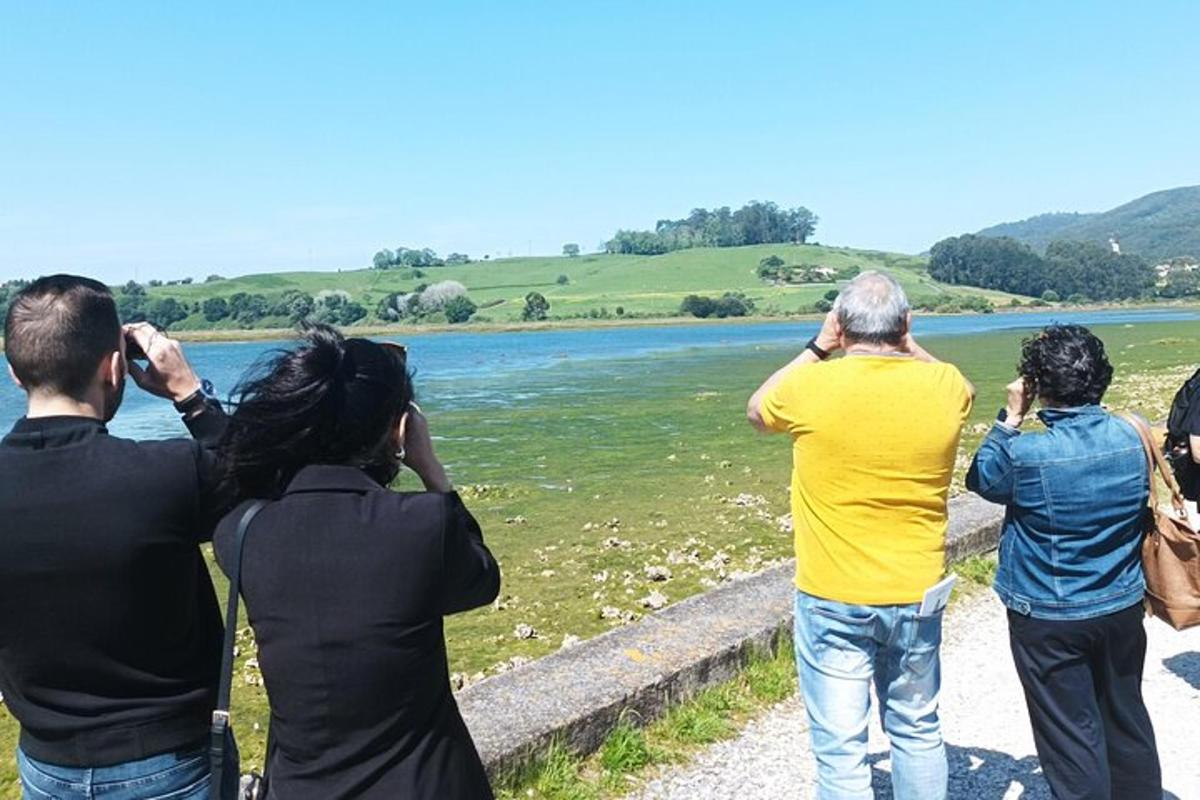 a group of people taking pictures of a river