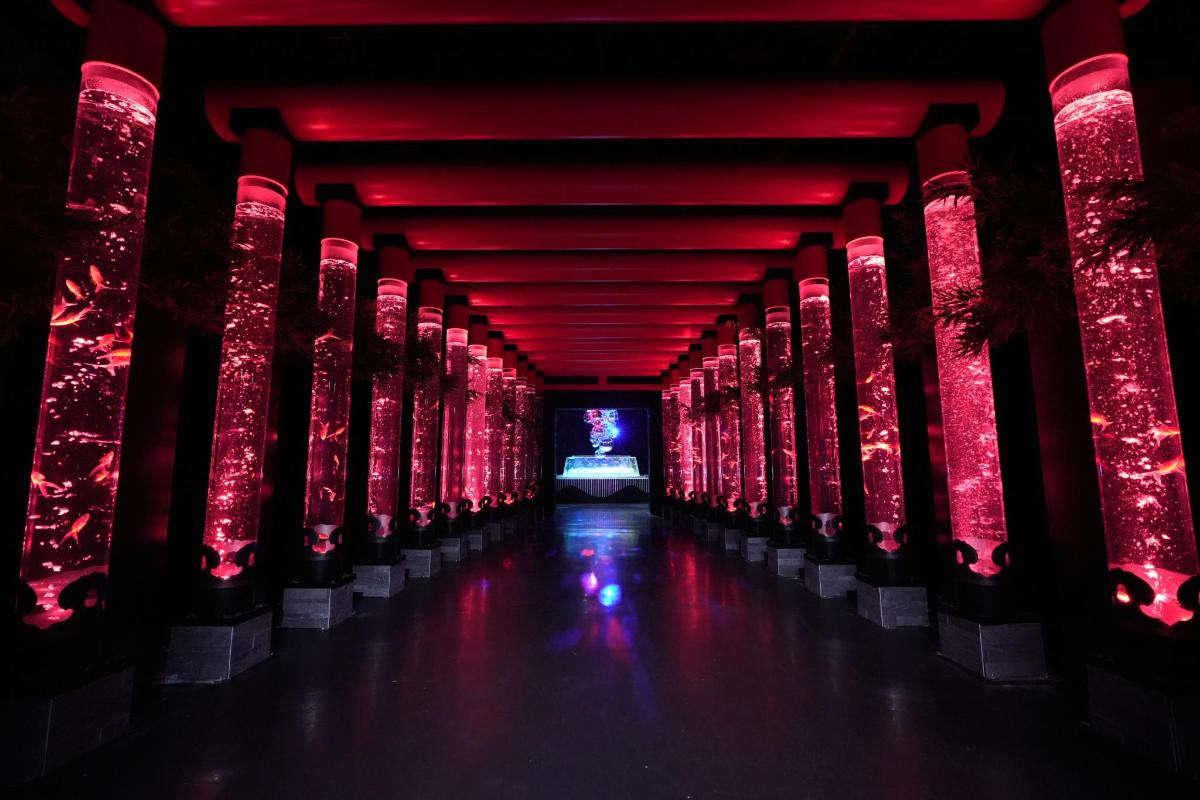 a long corridor with red lights in a building