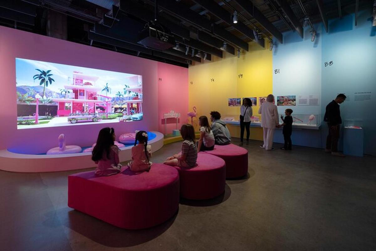 a group of children sitting on tables in a museum