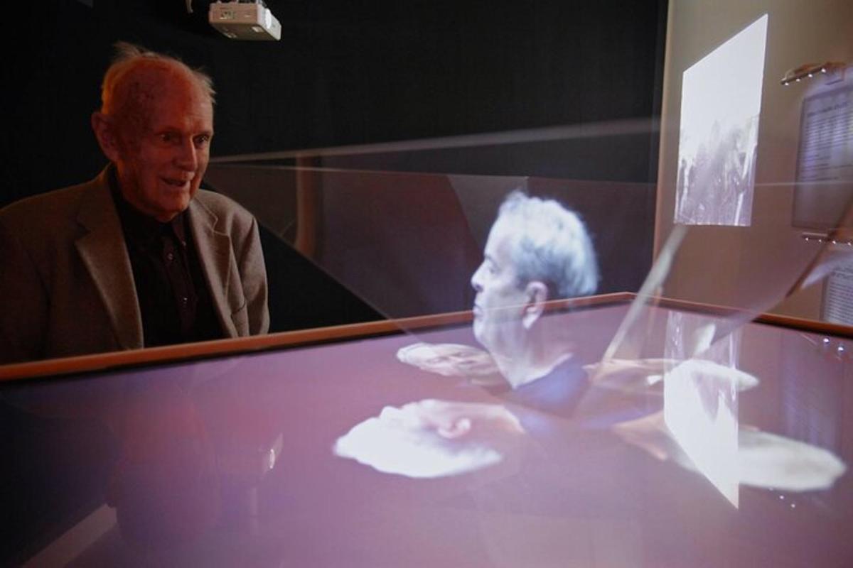 a man standing in front of a glass table