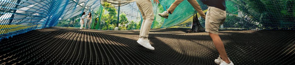 a man is walking across a cage in a cage