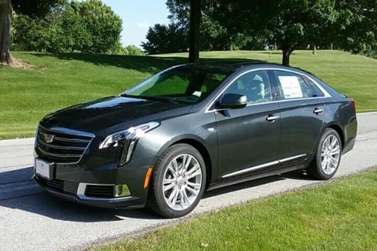 a black car is parked on a road