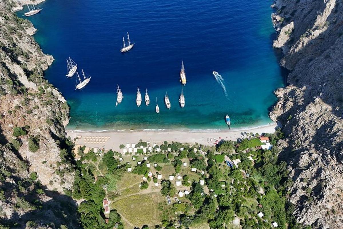an aerial view of a beach with boats in the water