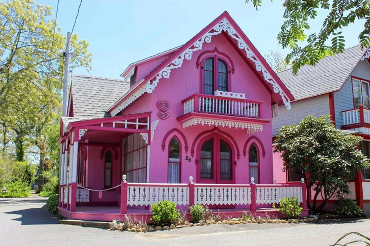 a pink house with a white fence