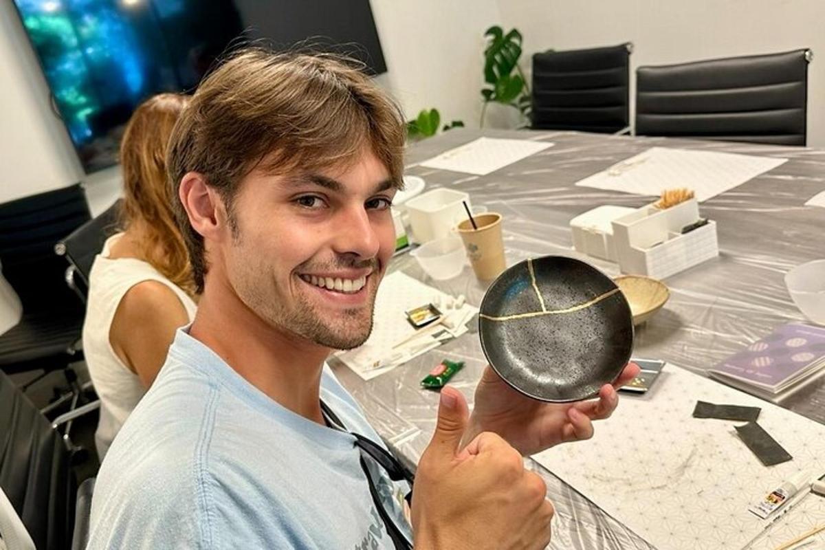 a man is holding a mirror at a table