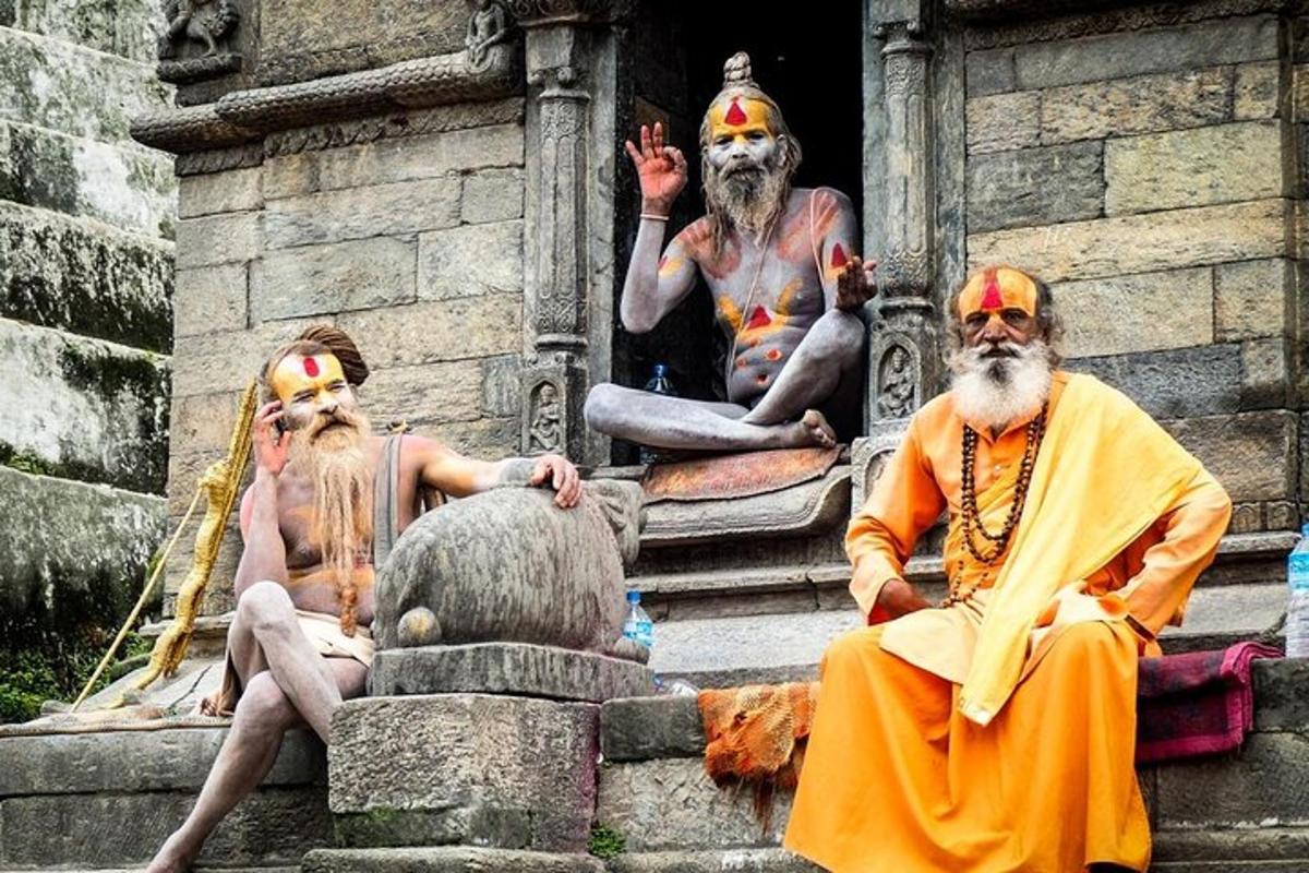 a group of three statues sitting on a building
