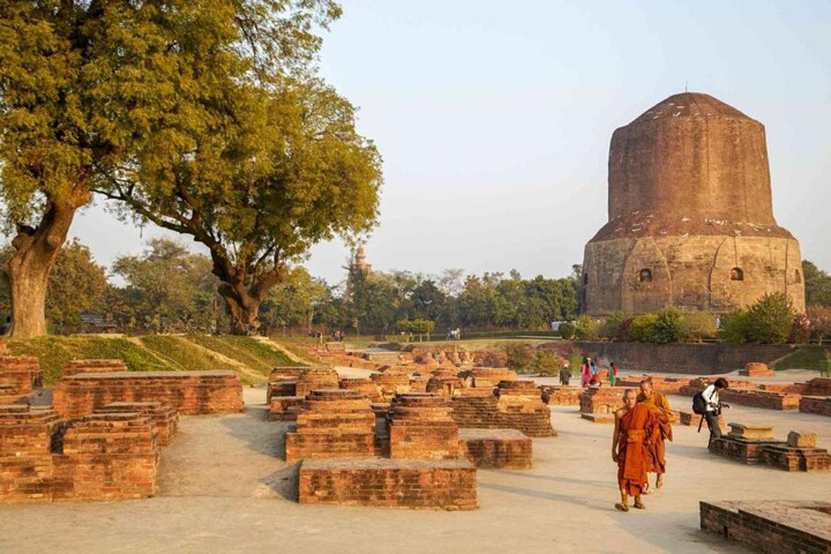 a monk walking past a pile of bricks in front of a building