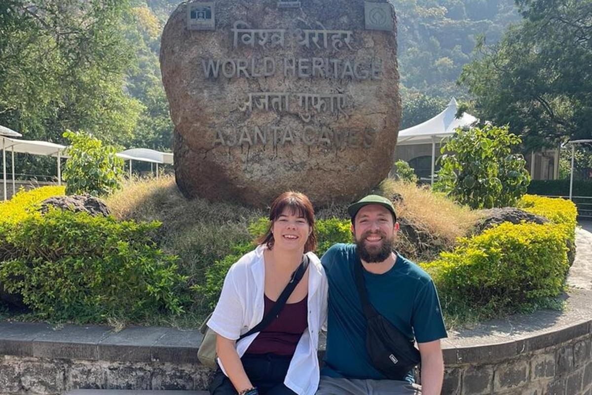 a man and a woman sitting in front of a monument