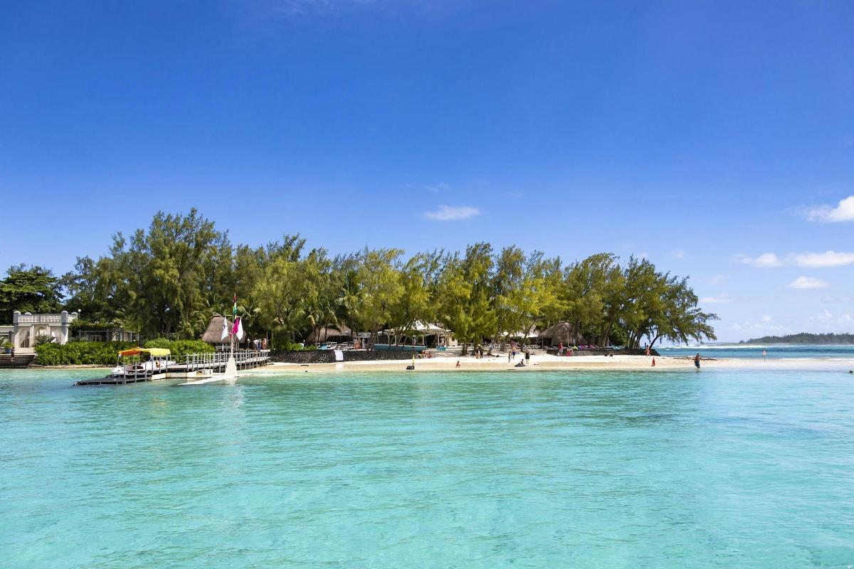 an island in the ocean with a beach and trees