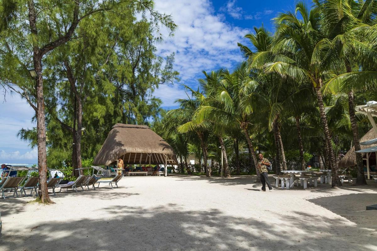 a resort with tables and chairs and palm trees