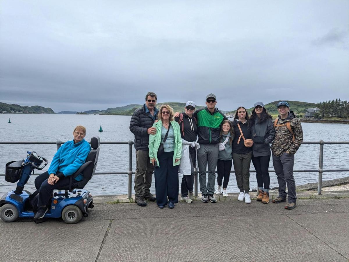 a group of people standing on a pier near the water