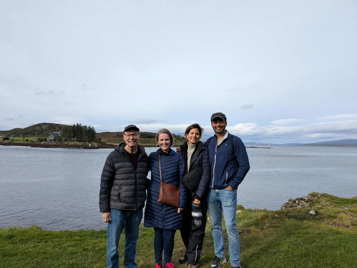 a group of people standing in front of a body of water