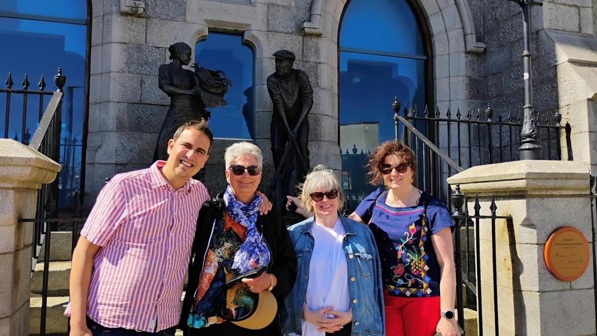 a group of people standing in front of a statue