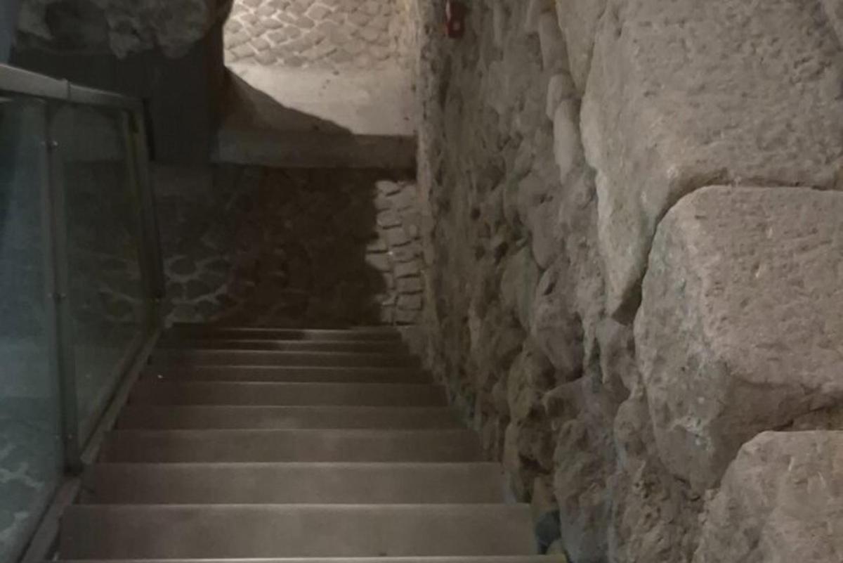 a stairway in a stone building with a stone wall