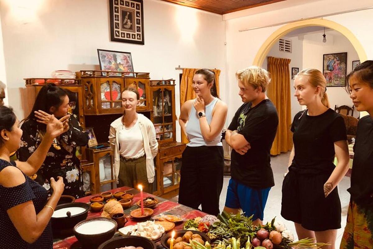 a group of people standing around a table with food