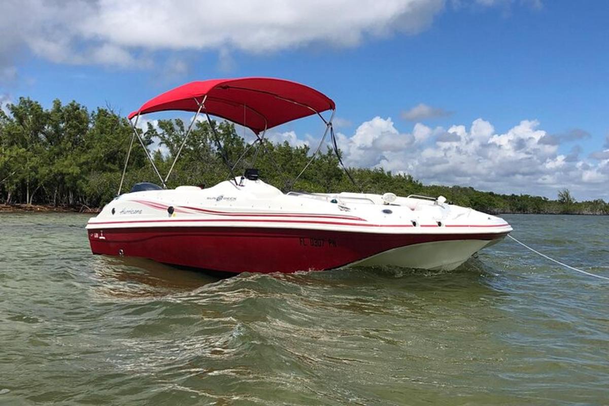 a red and white boat sitting in the water