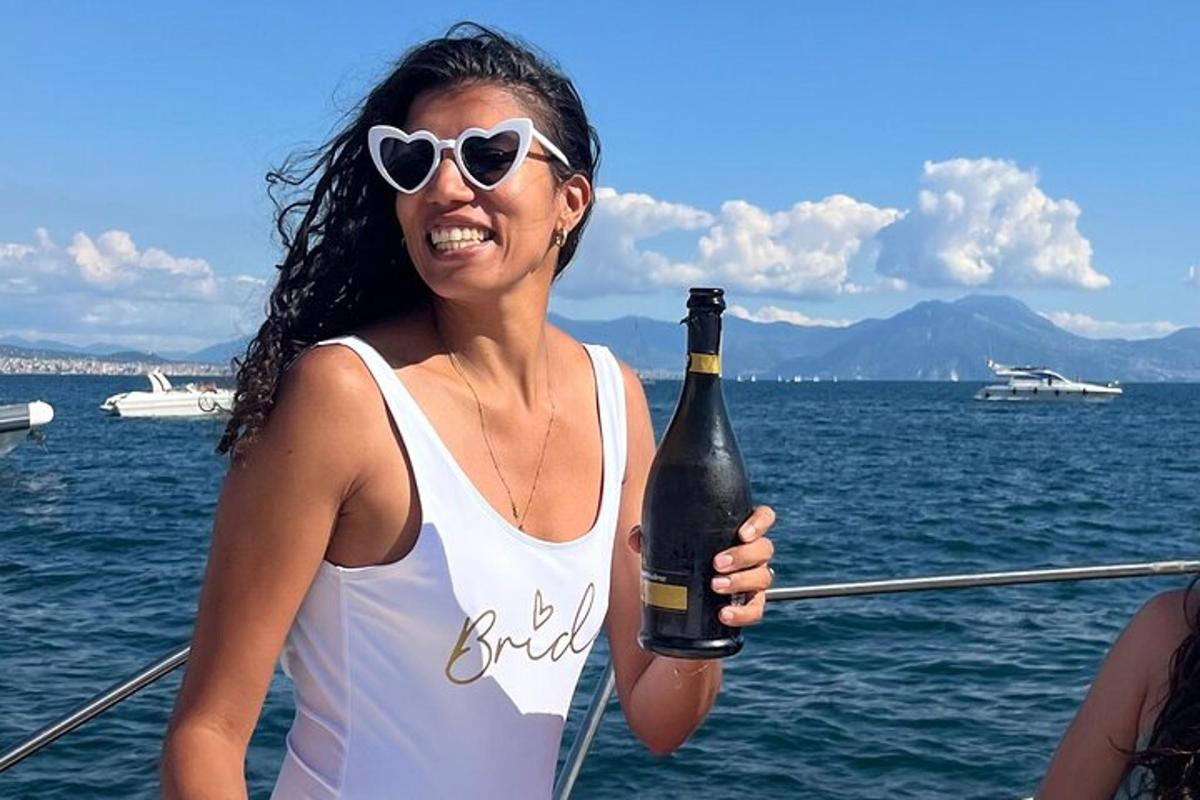 a woman holding a bottle of wine on a boat