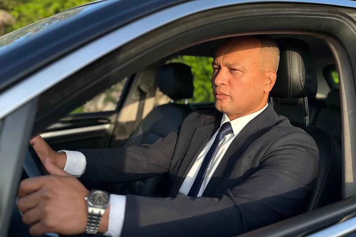 a man in a suit sitting in a car