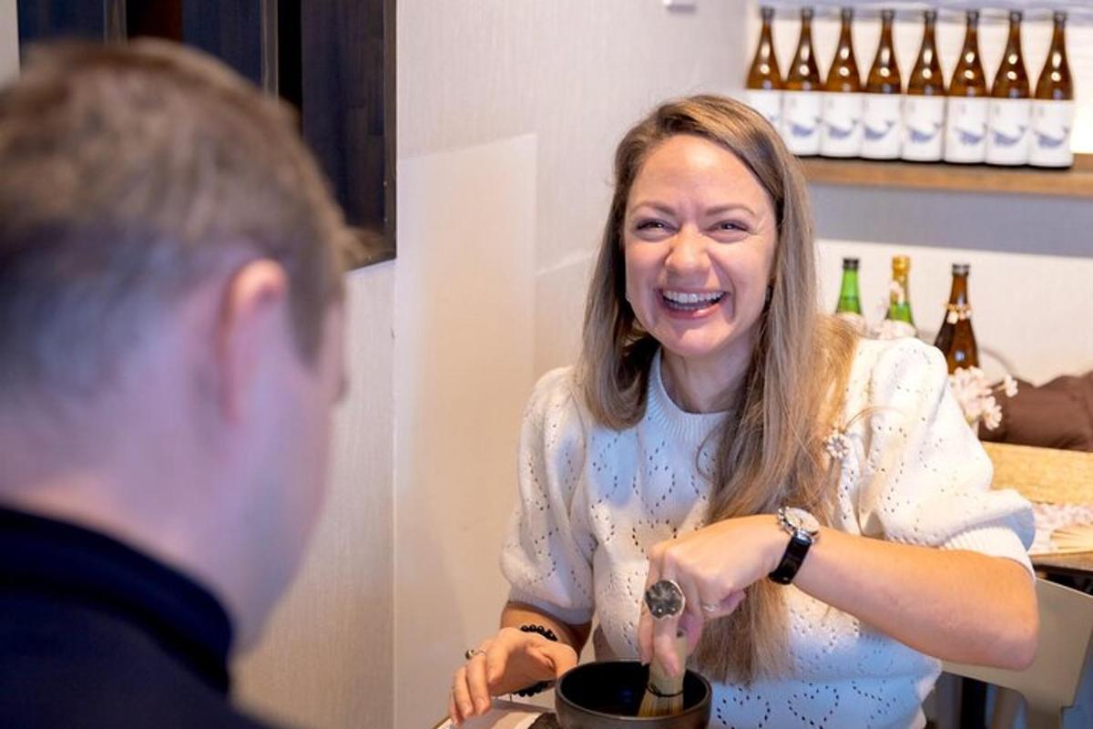 a man and a woman pouring wine into a pot