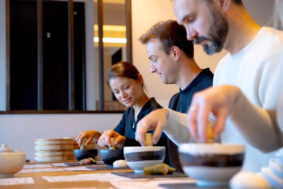 a group of people standing around a table with bowls