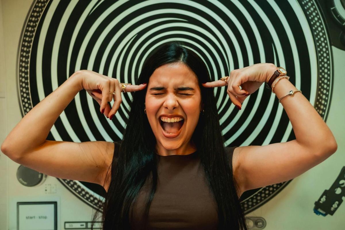 a woman is screaming in front of a mirror