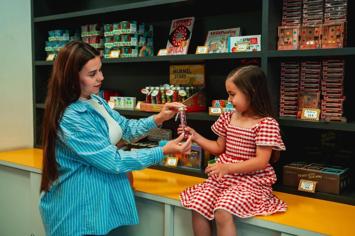 a woman and a little girl in a candy store