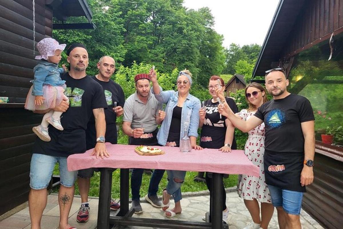 a group of people standing around a pink table