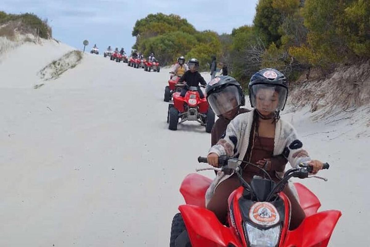 a group of people riding motorcycles on the beach