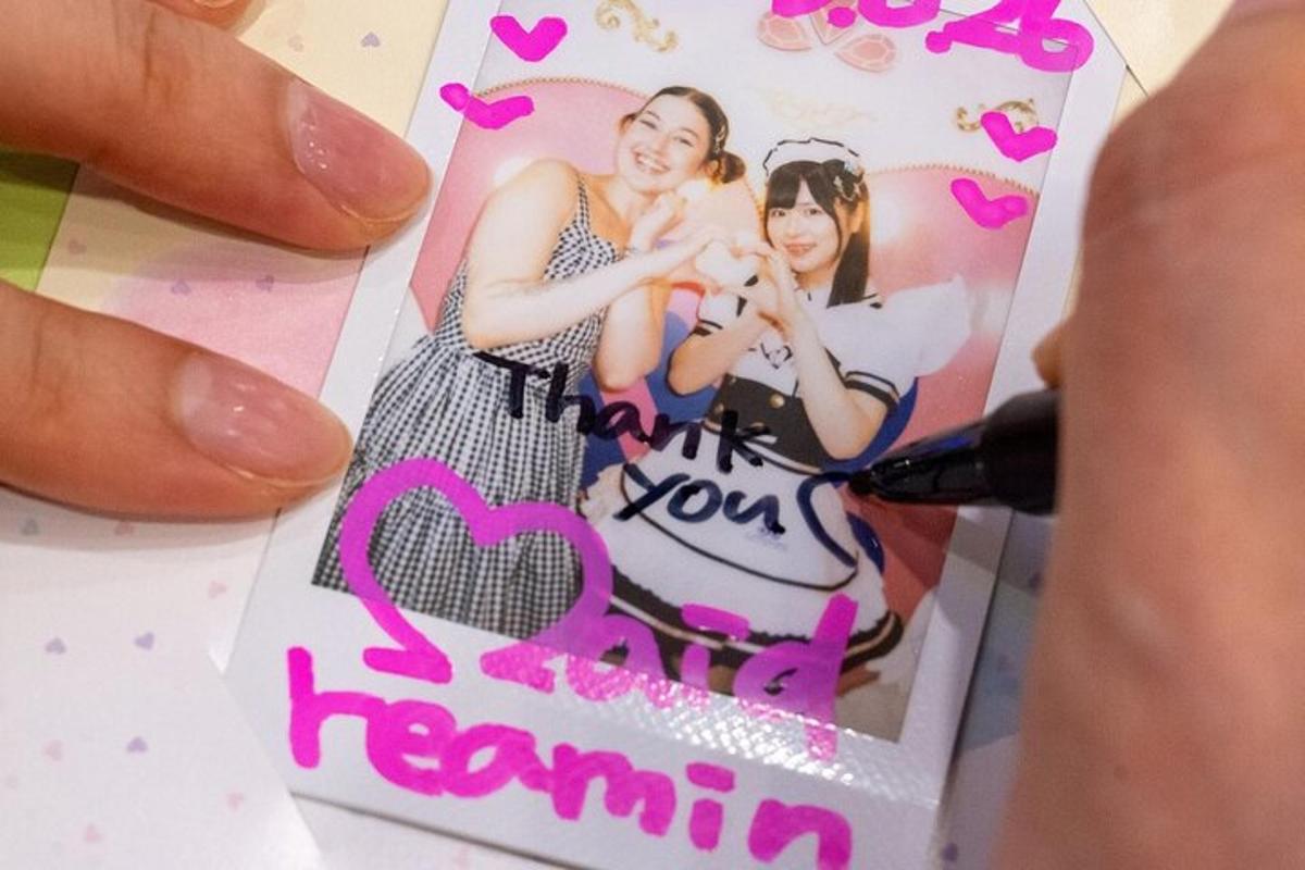 a person holding a card with a picture of two girls