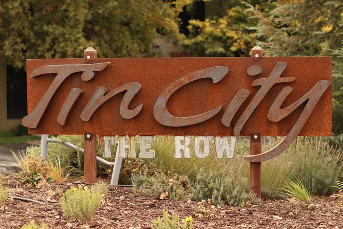 a sign that says tripping the row in a garden
