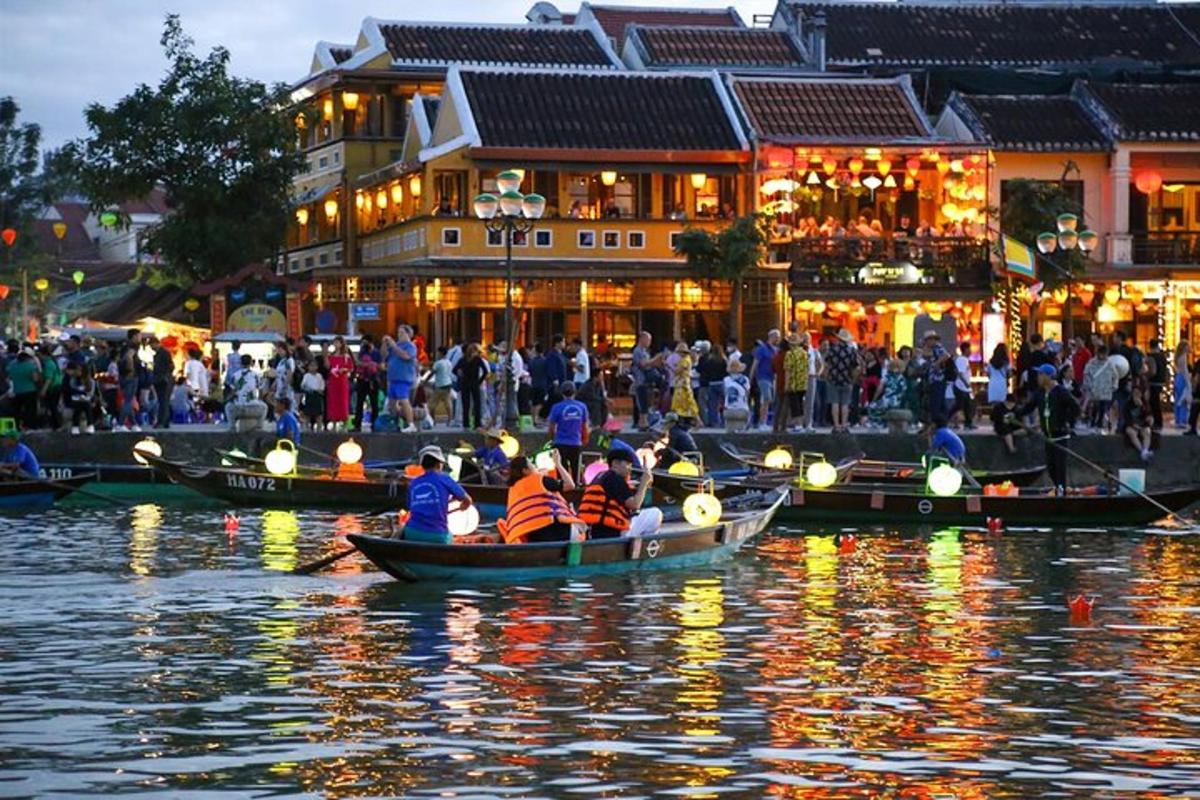 a group of people in boats on the water in front of buildings
