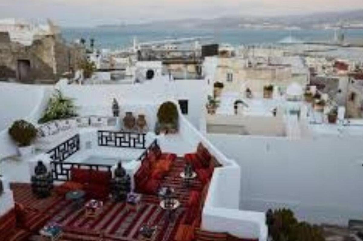 a view of a white building with a balcony