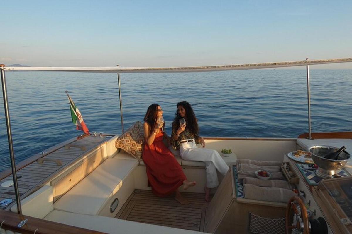 two women sitting on a boat in the water
