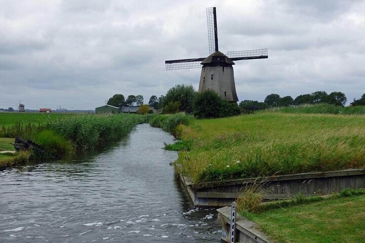 a windmill in a field next to a river