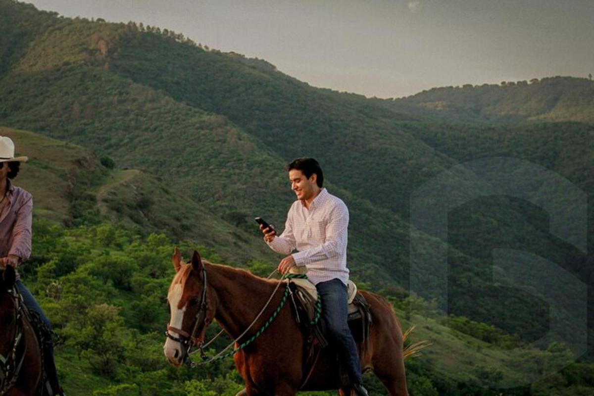 a man riding a horse in the mountains