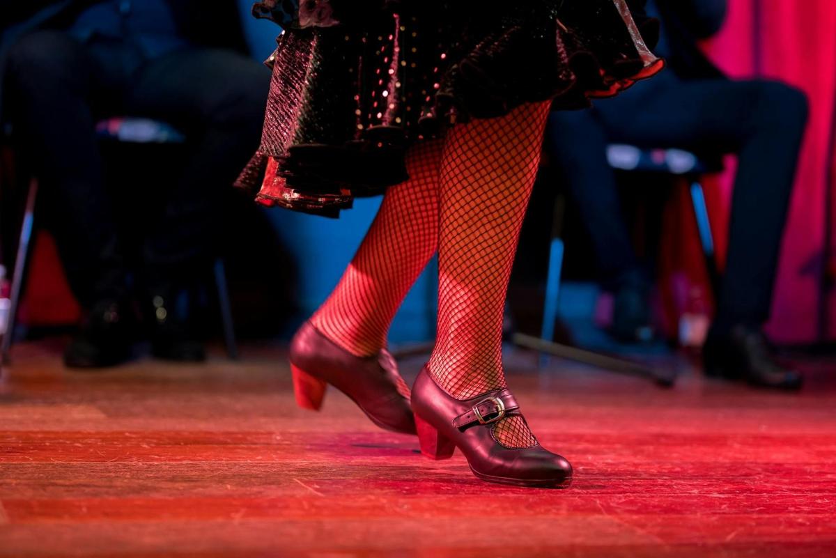 a woman in red leggings and red boots on a stage