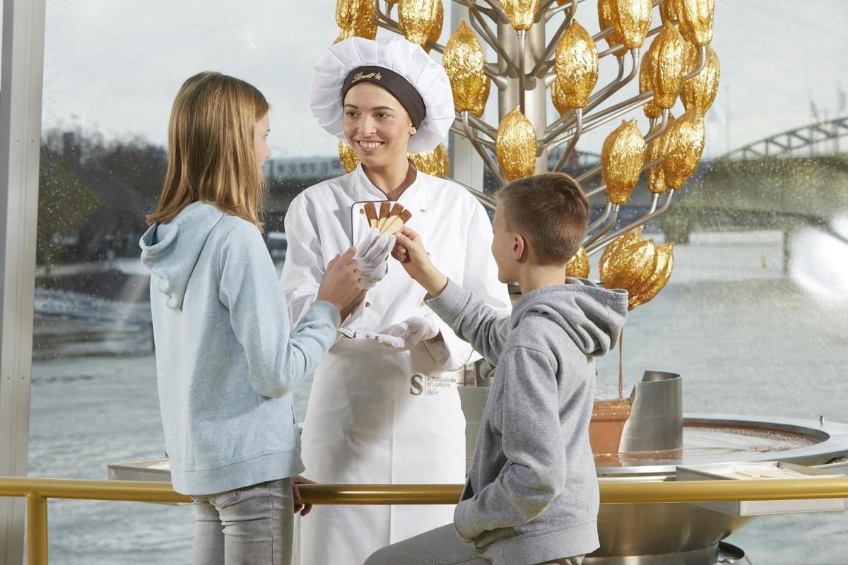 a woman and a child holding a boy holding food