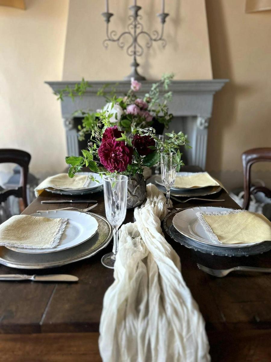 a table with plates and glasses and flowers on it