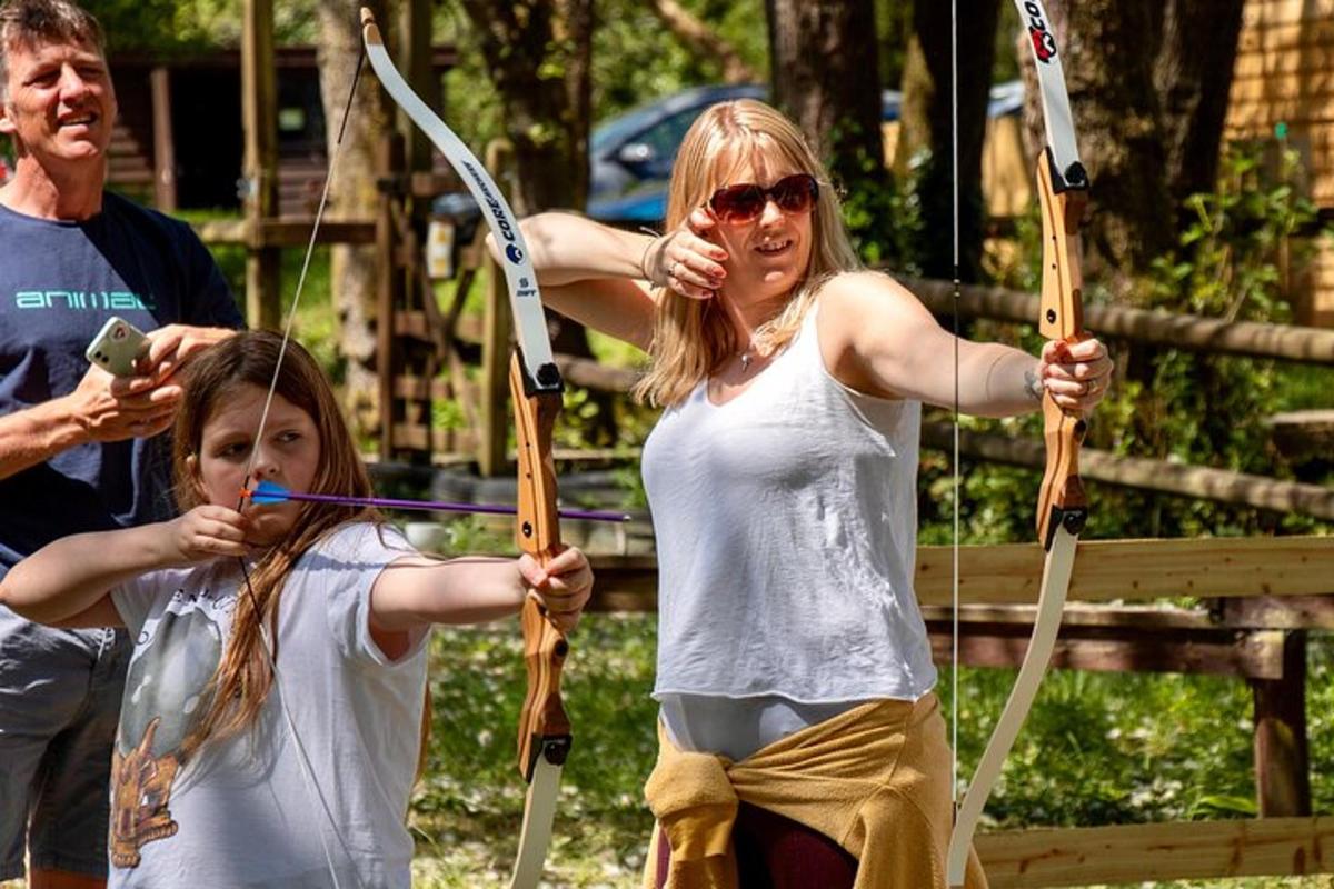 a woman and a little girl holding arrows