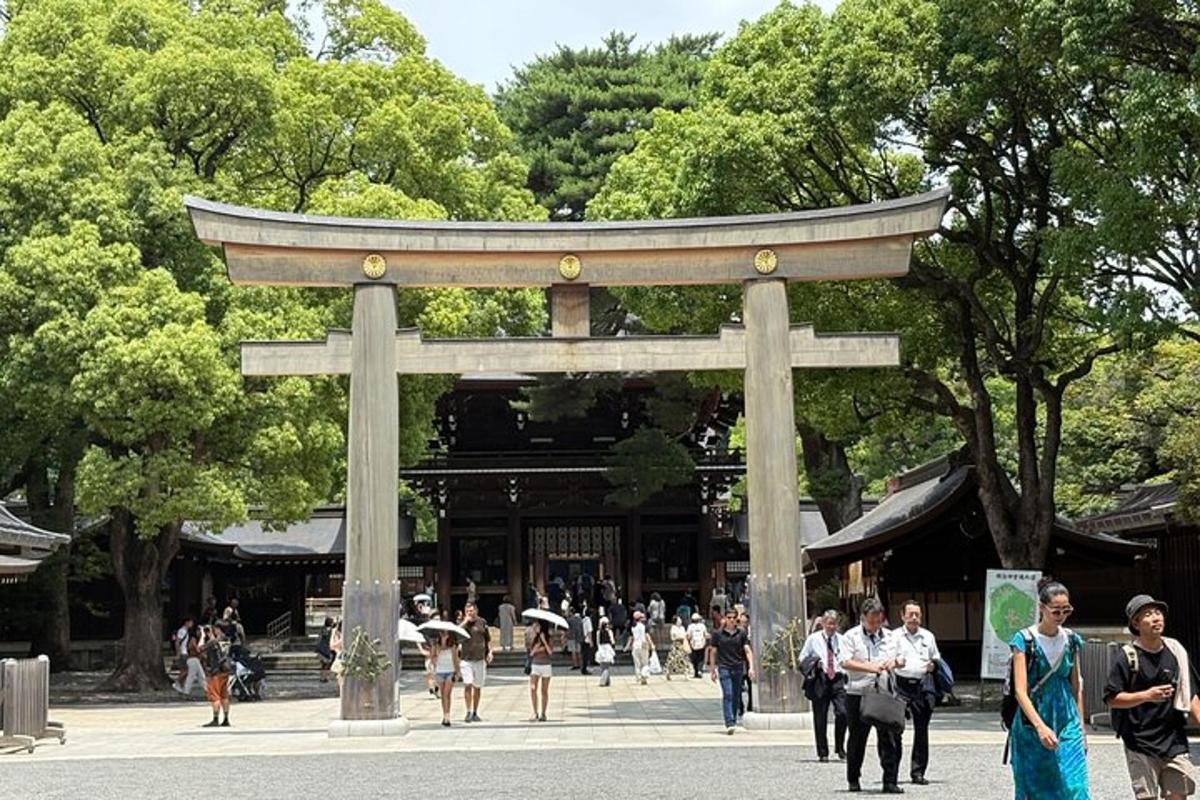 a torii gate in a park with people walking around