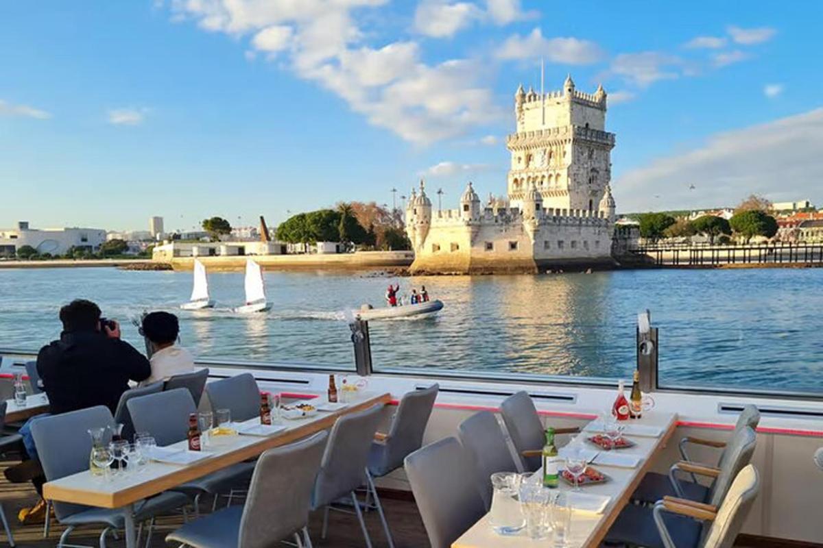 two people sitting at tables in front of a castle