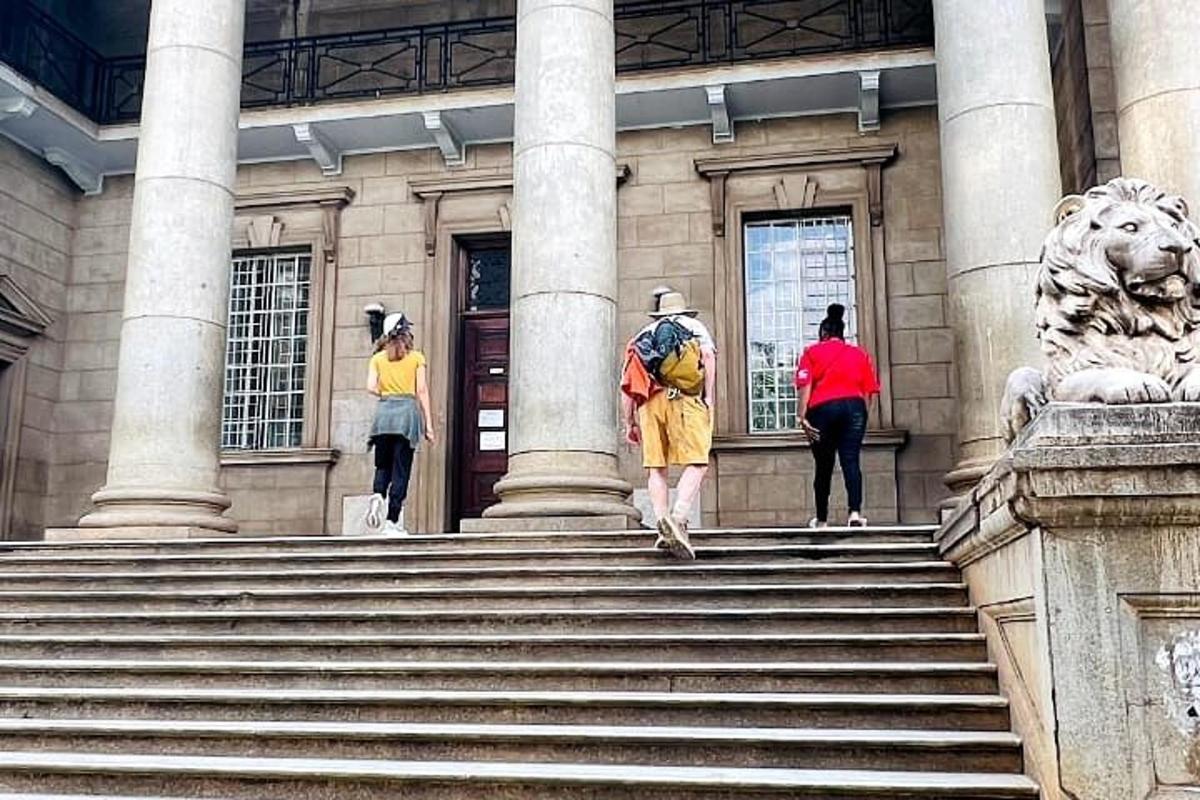 people walking up the stairs of a building