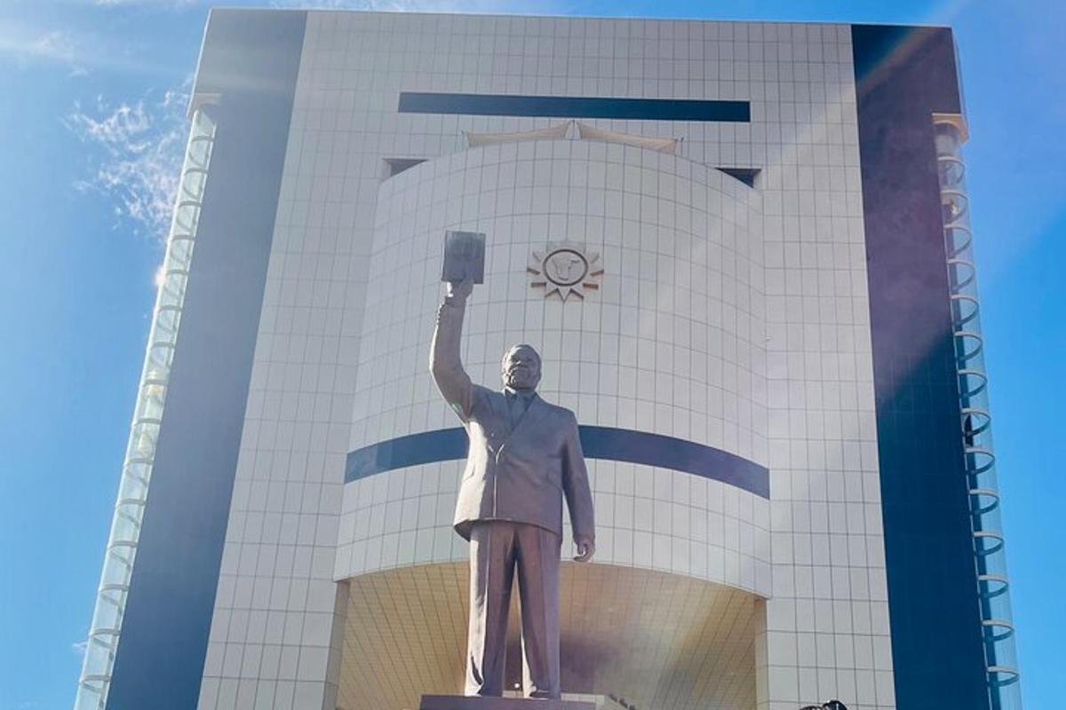 a statue of a man standing in front of a building