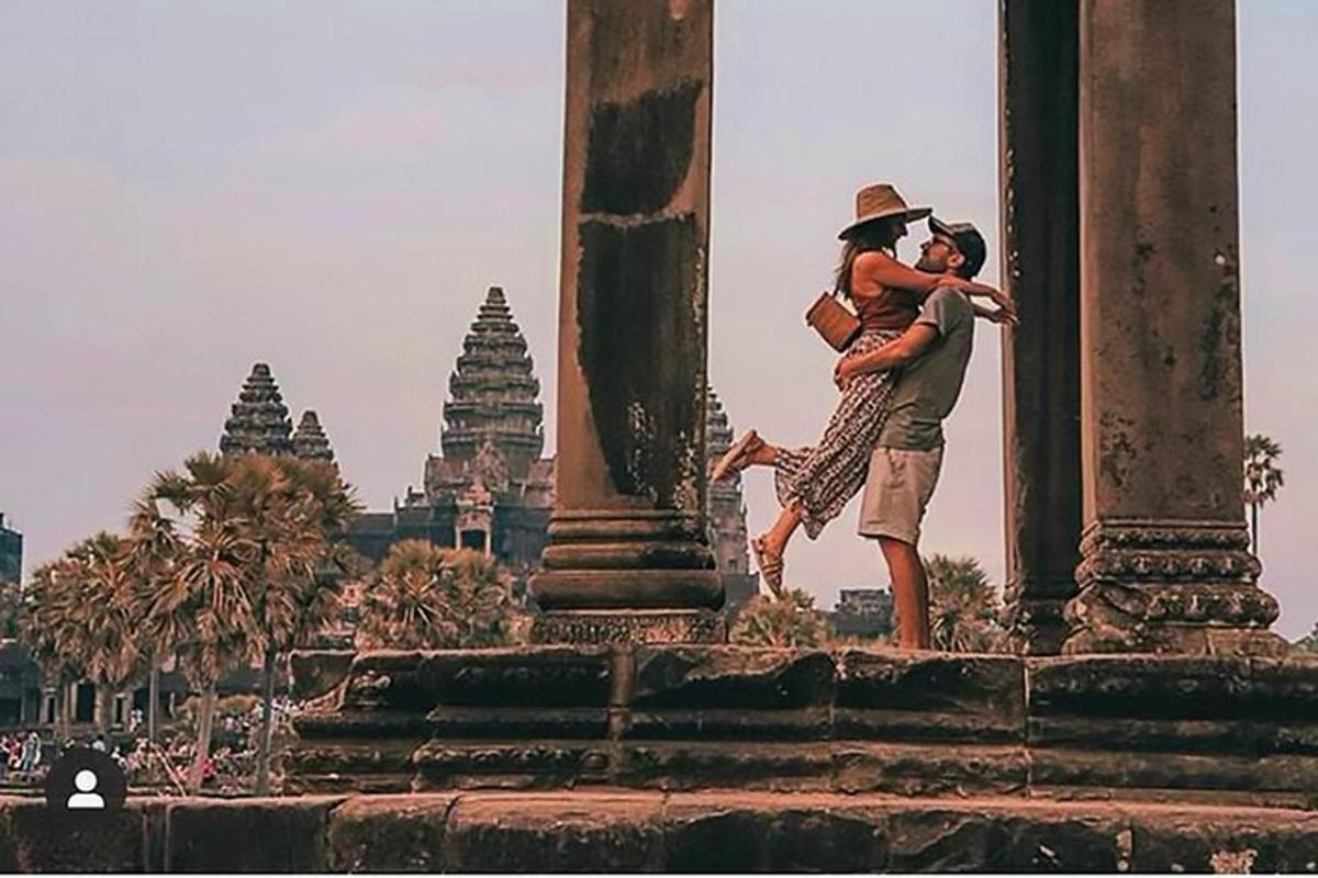 a man hugging a woman in front of a temple
