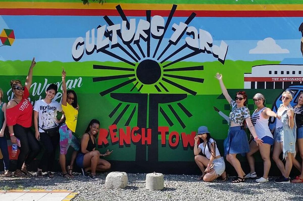 a group of women are posing in front of a wall