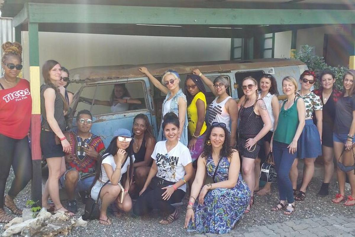 a group of women posing for a picture in front of a van