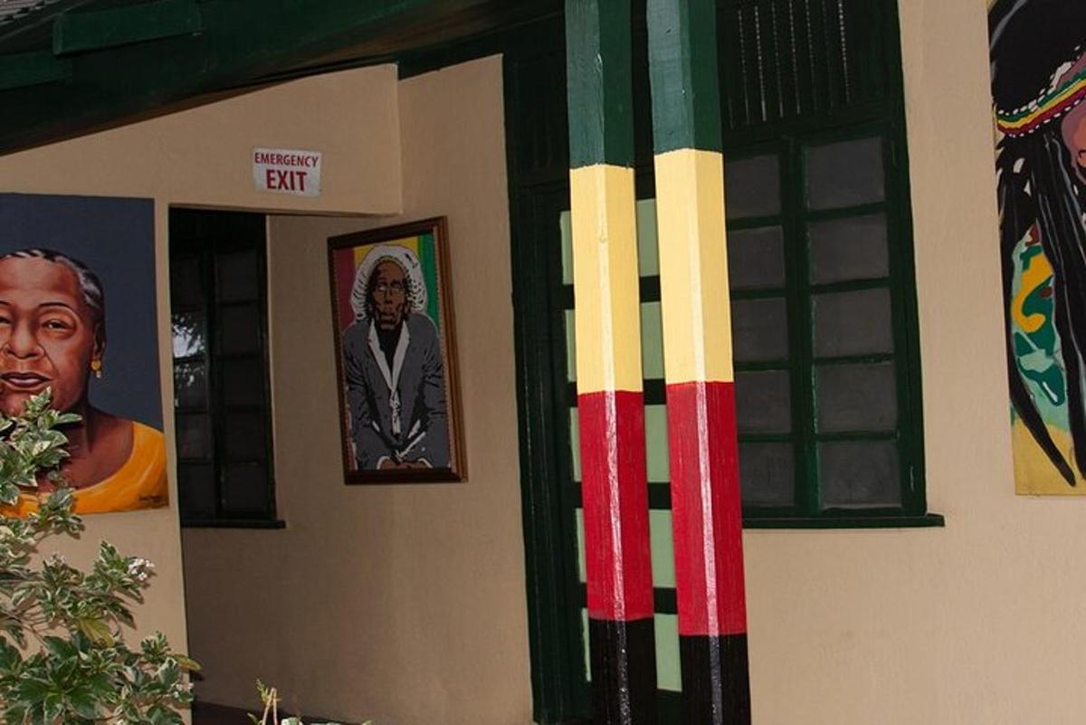 a wall with paintings and a picture of a man