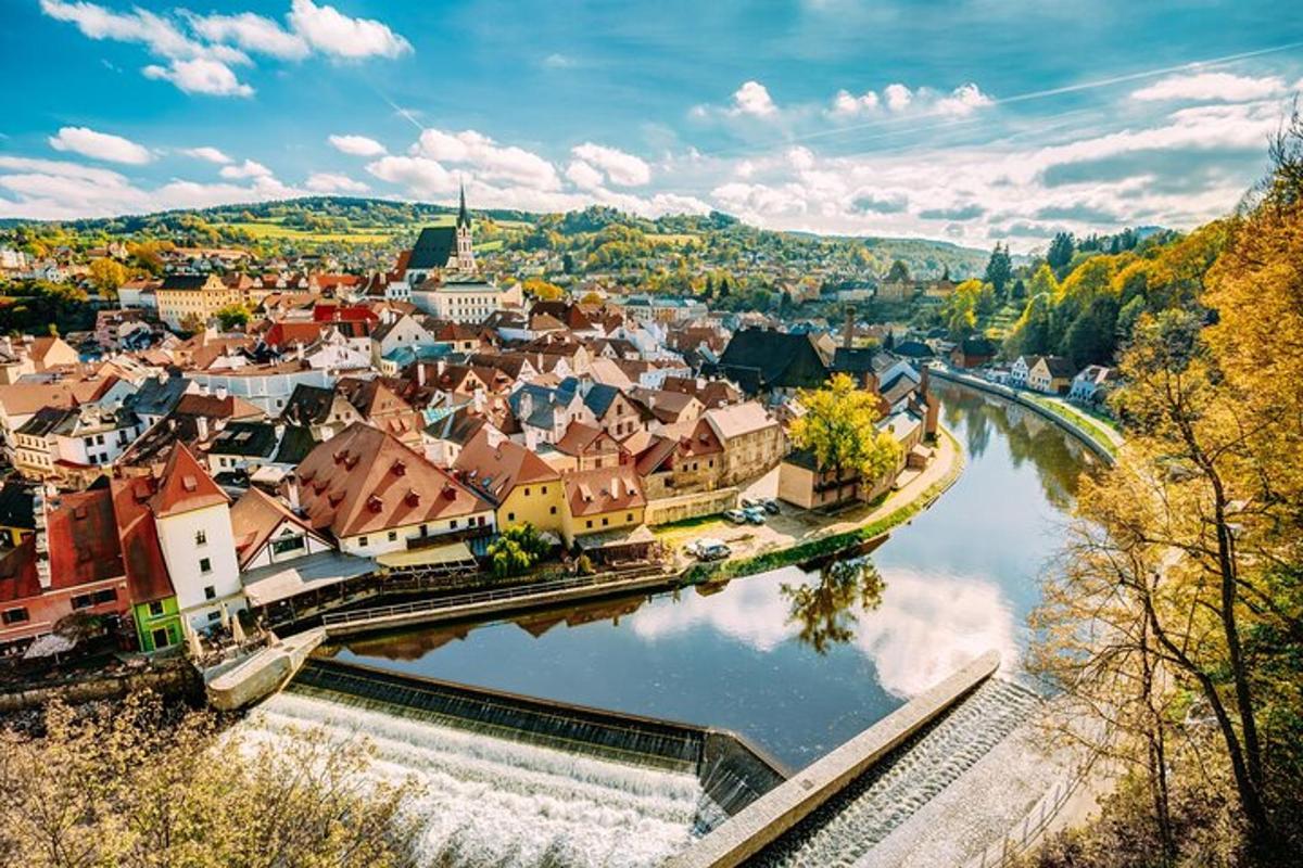 an aerial view of a town next to a river