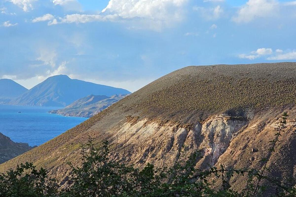 a view of a mountain with the ocean in the background