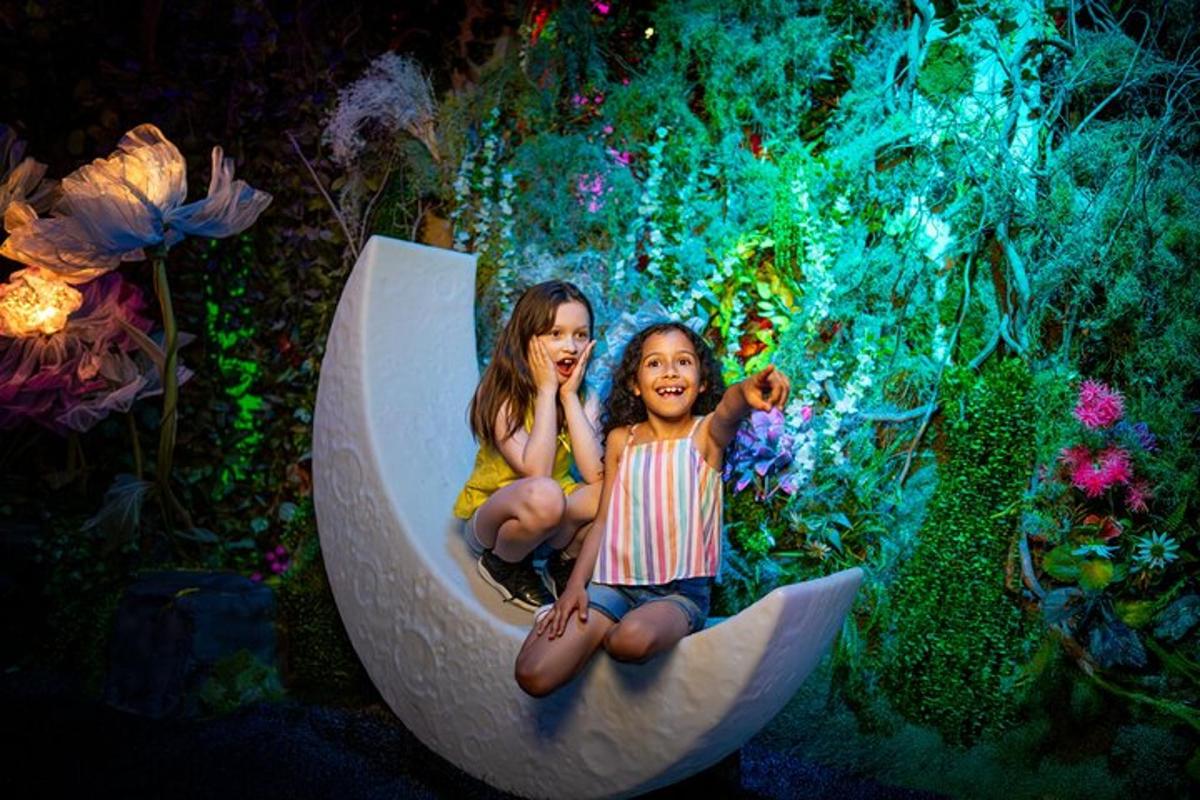 two little girls sitting on a banana boat in a display